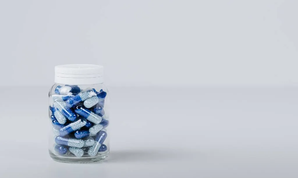 Bottle with blue pills